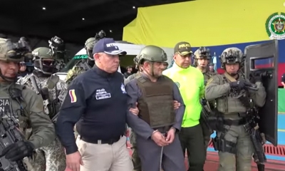 "Otoniel", esposado de manos y pies y portando un chaleco antibalas, fue entregado este miércoles por la Policía colombiana a agentes de Estados Unidos. Foto: Captura de pantalla