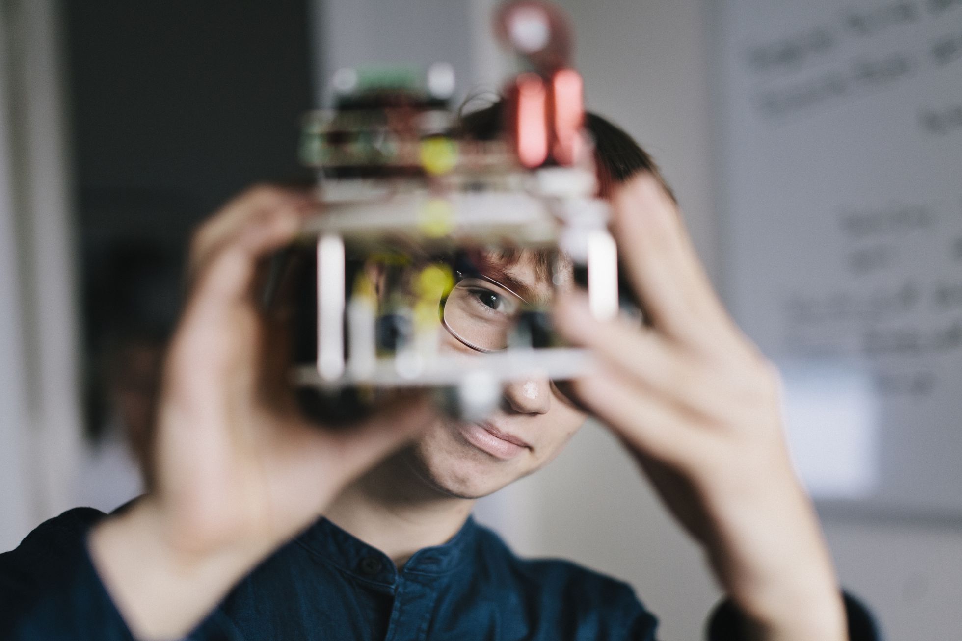 Un adolescente analiza un robot electrónico casero. Foto: El País.