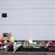 Agujeros de bala y flores con mensajes de condolencia frente al garaje de una casa de Amberes donde fue asesinada una niña por disparos de narcotraficantes. Foto: DW