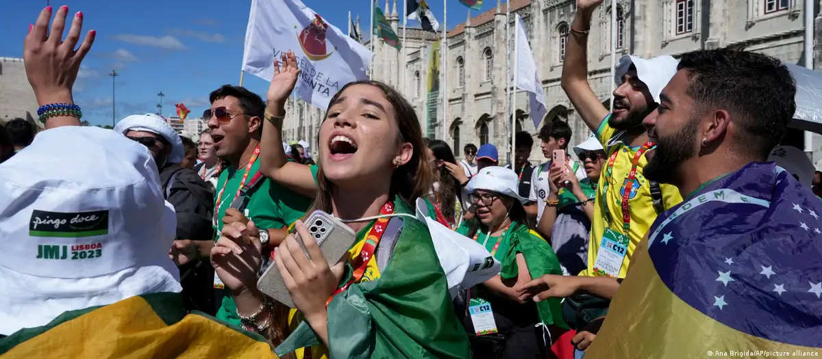 Jóvenes peregrinos brasileños cantan y bailan frente al monasterio de los Jerónimos en Lisboa, el martes 1 de agosto de 2023. Foto: DW.