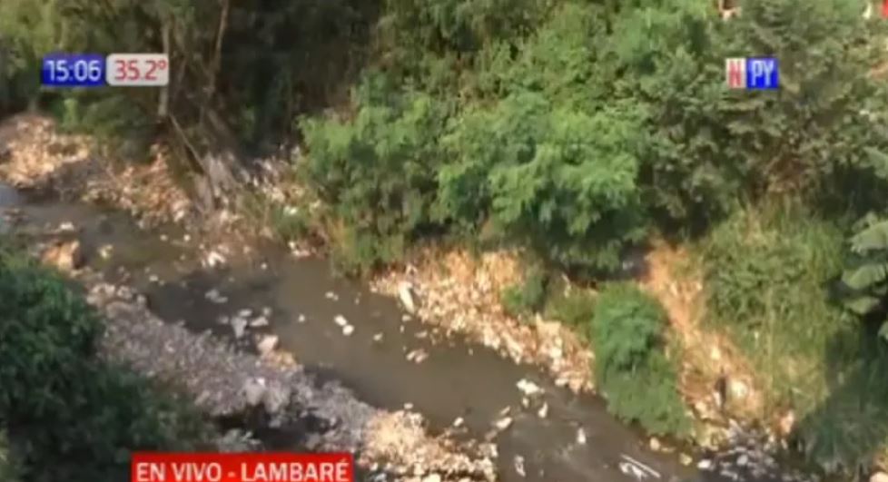 Un cuerpo envuelto en una alfombra fue hallado en un cauce hídrico de Lambaré. Se desconoce la identidad. Foto: Captura NPY