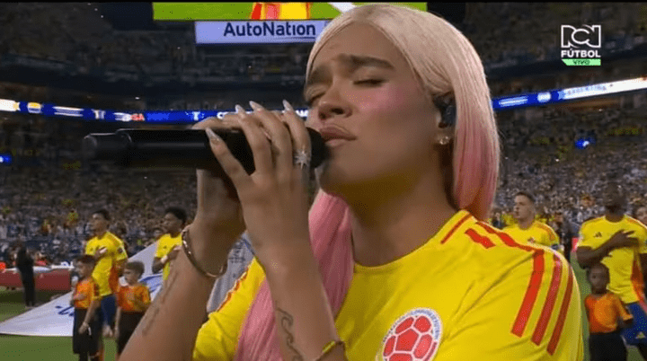 Karol G entonando el himno nacional de Colombia en la final de Copa América. Foto: Infobae.