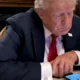 Donald Trump mirando sus redes sociales.Foto: X