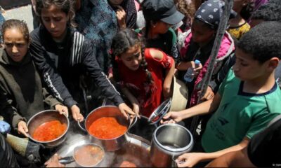 Menores palestinos reciben comida en una cocina de caridad en el sur de Gaza.Imagen: Hatem Khaled/REUTERS/DW